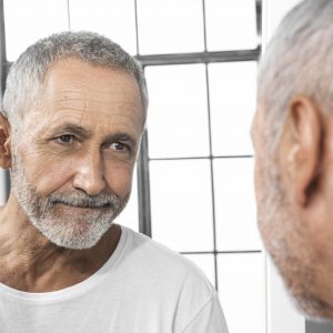 close-up-man-looking-mirror-min